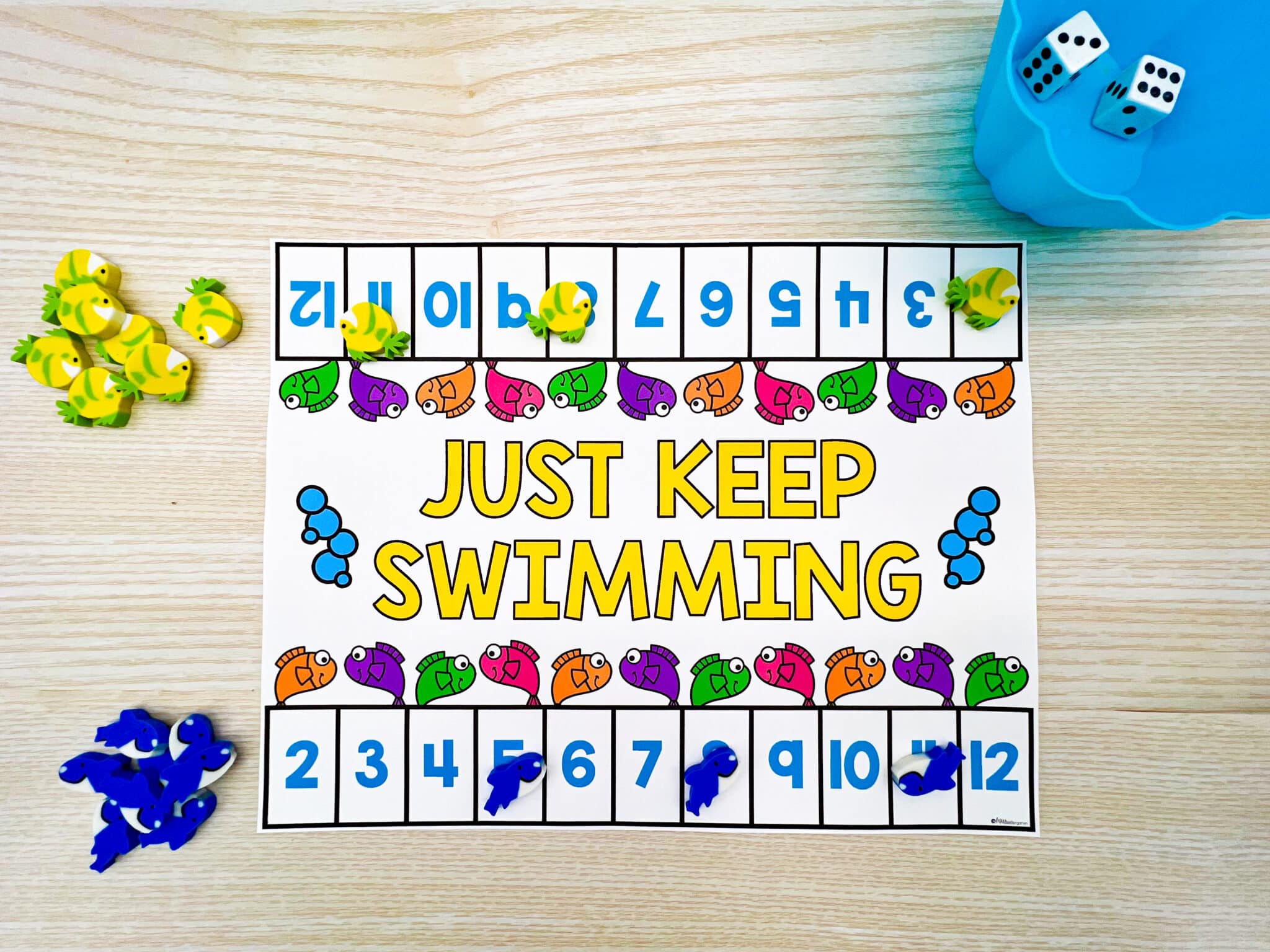 Just Keep Swimming game mat with fish mini erasers as game pieces