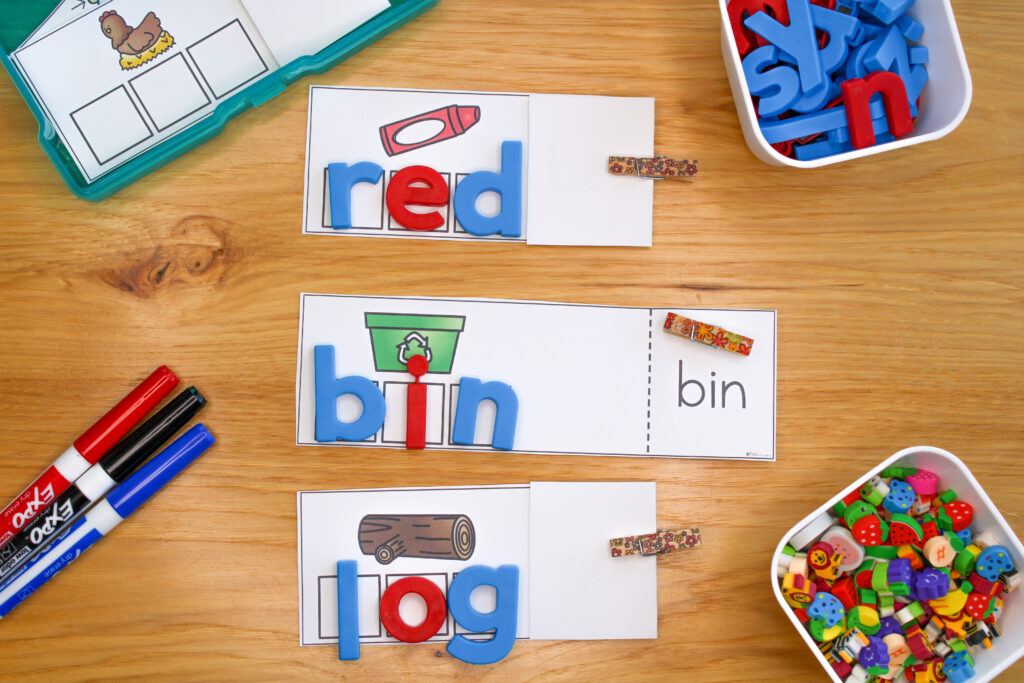 Three write and reveal cvc word activities being used with letter tiles