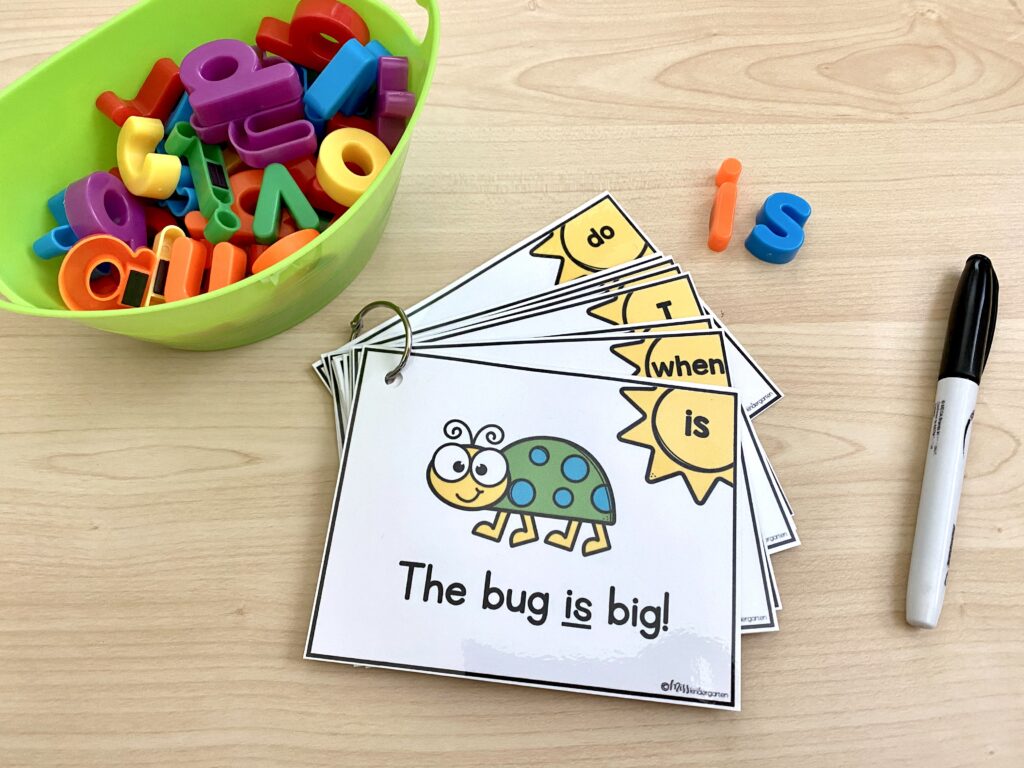 Sight word sentence task cards are attached to a binder ring. Magnetic letters are also in use.