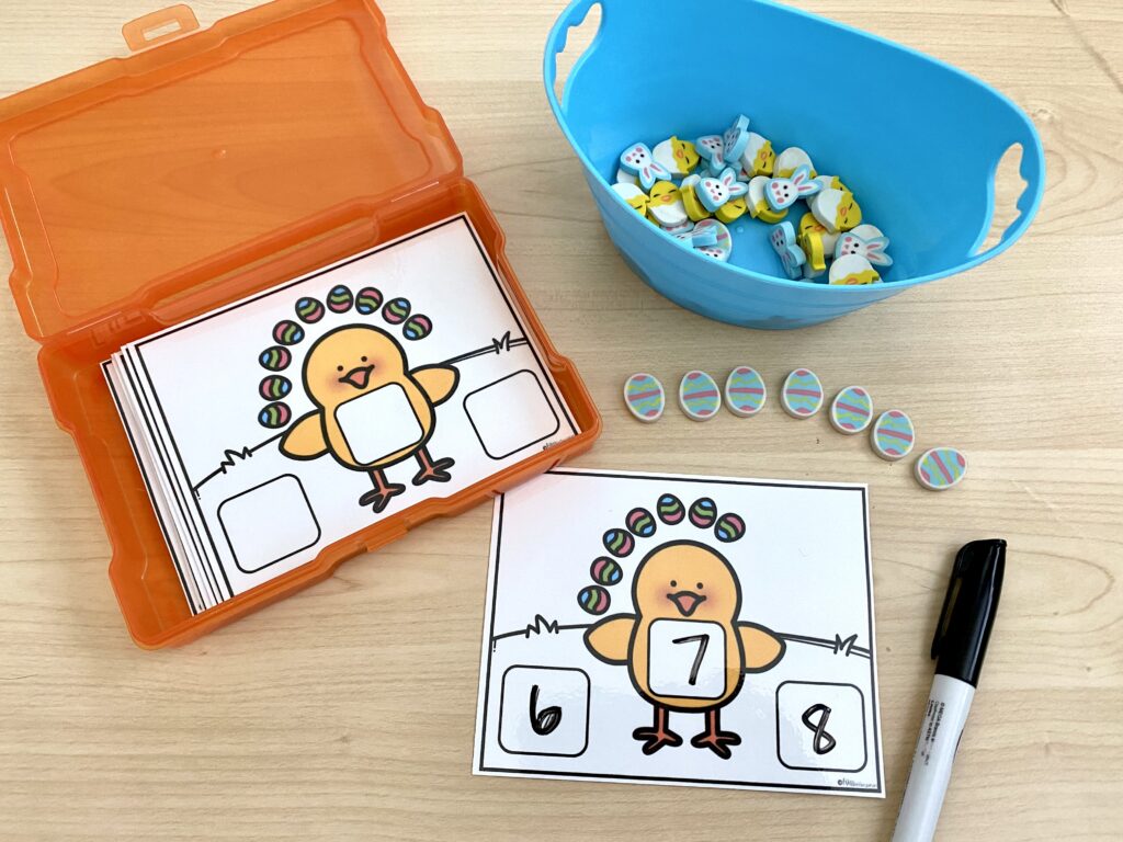 Before and after sequencing task cards are being used on a desk, along with mini Easter egg erasers.
