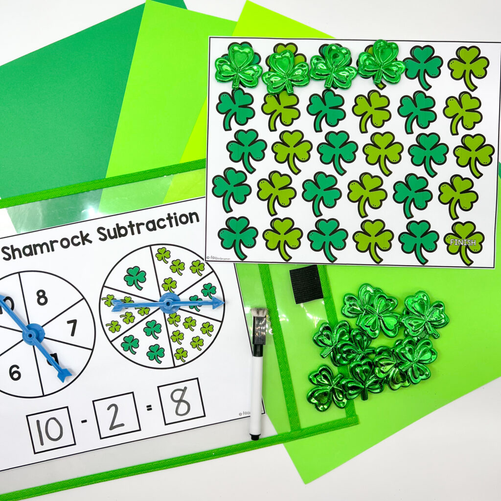 Shamrock Subtraction center in use with shamrock manipulatives being used to cover the game board.