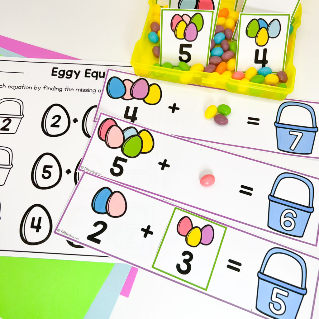 Jelly bean candies and number cards are being used to complete an Easter themed addition center
