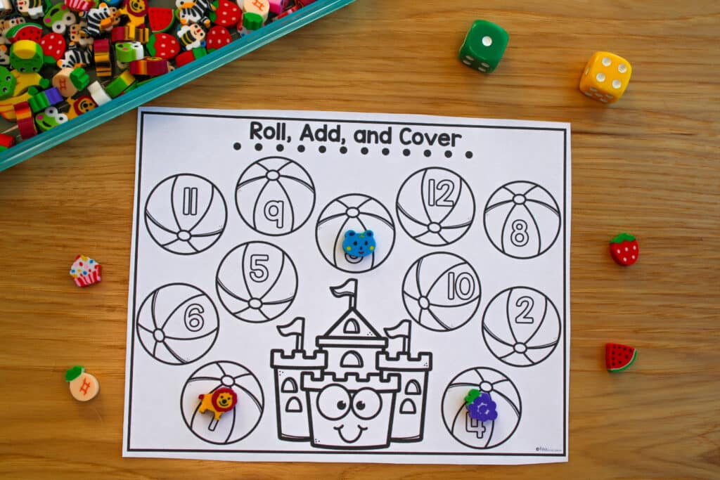 A beach-themed roll and cover addition practice activity has been printed in black and white.