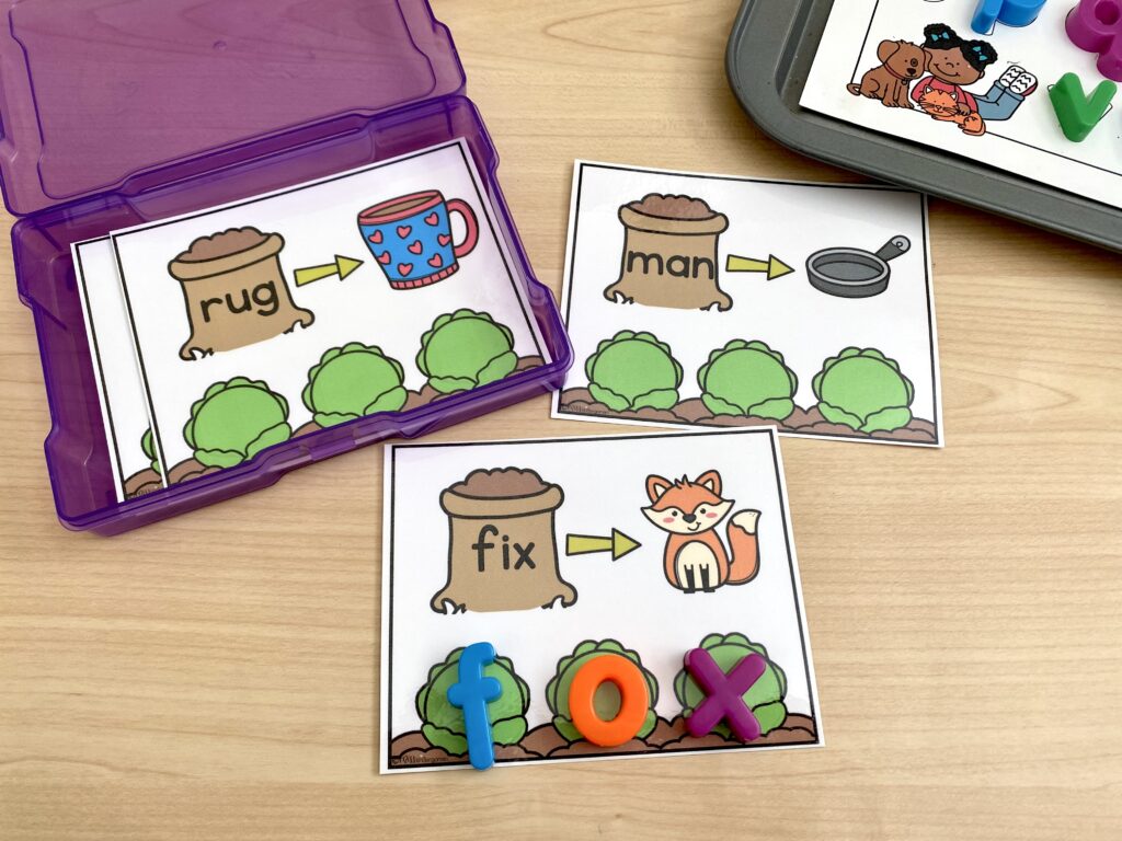 A garden-themed CVC word building activity is being used with magnetic letters.