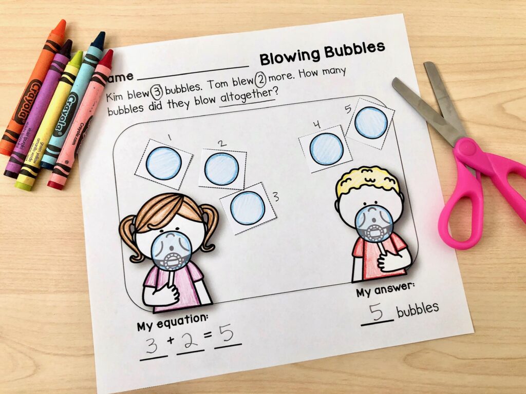 A completed story problem worksheet sits on a desk, with cut and colored bubbles illustrating a bubble-blowing story problem.