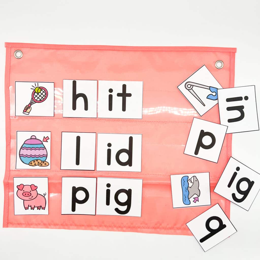 A pink pocket chart with letter cards and pictures