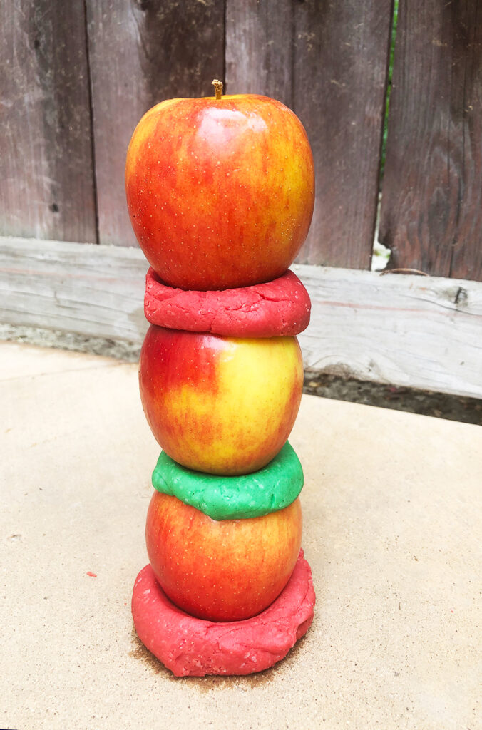 A tower built with apples and play dough