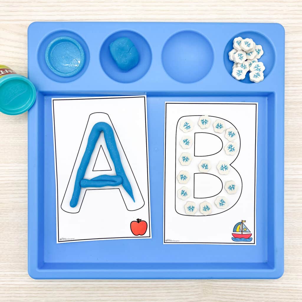 Filling in the letters A and B with play dough and snowflake erasers