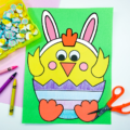 baby chick craft on a desk with scissors and crayons