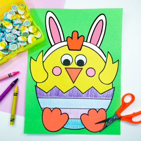 baby chick craft on a desk with scissors and crayons